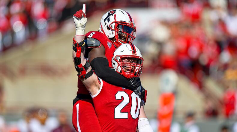 Miami’s Adam Trick (20), a Wayne High School grad, celebrates a tackle during a game last season. KYLE HENDRIX / CONTRIBUTED