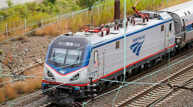 FILE - An Amtrak train departs 30th Street Station in Philadelphia on Oct. 27, 2021. Wisconsin Gov. Tony Evers said Tuesday, Dec. 20, 2022, that he is not ruling out the use of state funds to construct a passenger rail line between the cities of Madison and Milwaukee that would also expand connections between Chicago and St. Paul, Minn. (AP Photo/Matt Rourke, File)