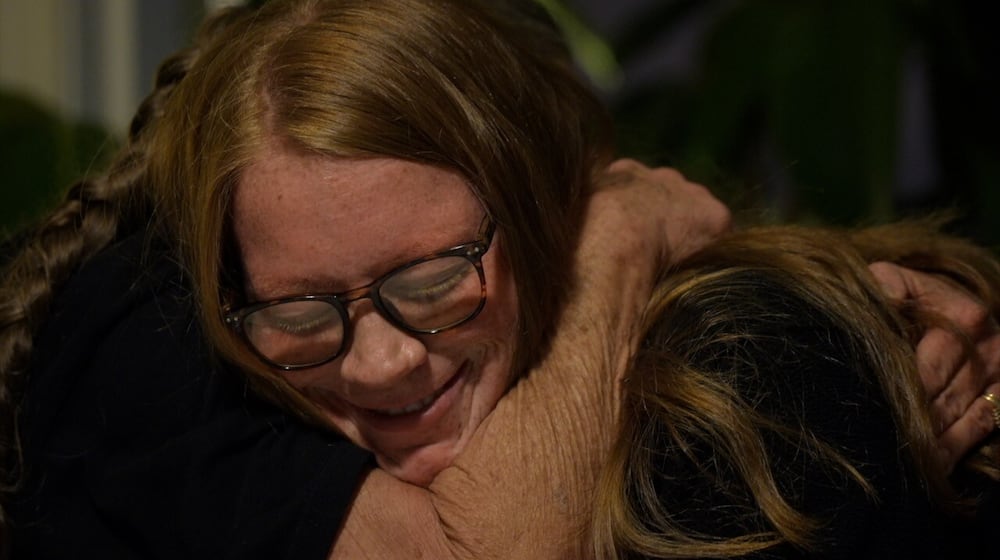 Payton Herres hugs her organ donor's mom, Mary Cutter. It's the first time they've met in person. KEITH BIERYGOLICK/WCPO