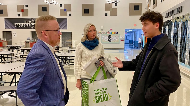 Outside a recent Lakota Board of Education meeting, newly elected, 18-year-old Benjamin Nguyen chats with Butler Tech Superintendent William Sprankles and Assistant Superintendent Kristen AbuDakar sharing some of his ideas on the future of career tech education in Lakota Schools. (Photo By Michael D. Clark/Journal-News)