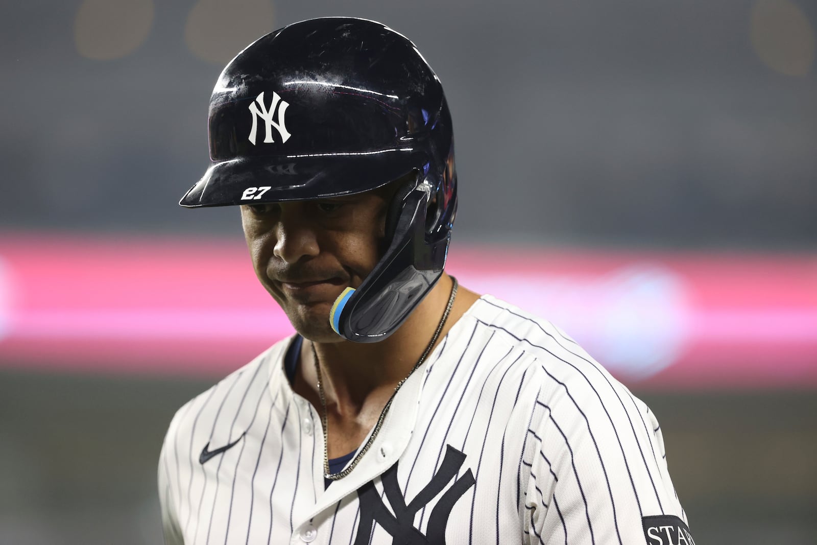 New York Yankees' Giancarlo Stanton walks to the dugout after flying out to Los Angeles Angels shortstop Zach Neto during the ninth inning of a baseball game Tuesday, June 17, 2025, in New York. (AP Photo/Pamela Smith)