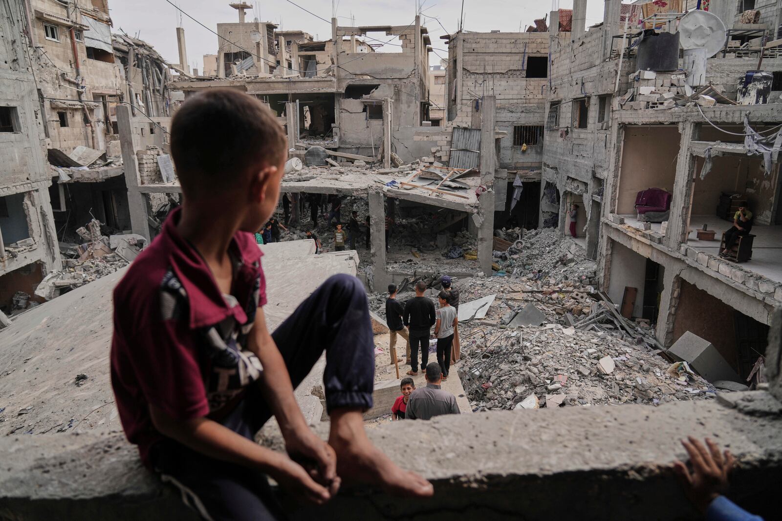 Palestinians inspect the rubble of the Al-Lahham family's home, destroyed by Israeli airstrikes in Khan Younis, Gaza Strip, on Thursday, May 15, 2025. (AP Photo/Abdel Kareem Hana)