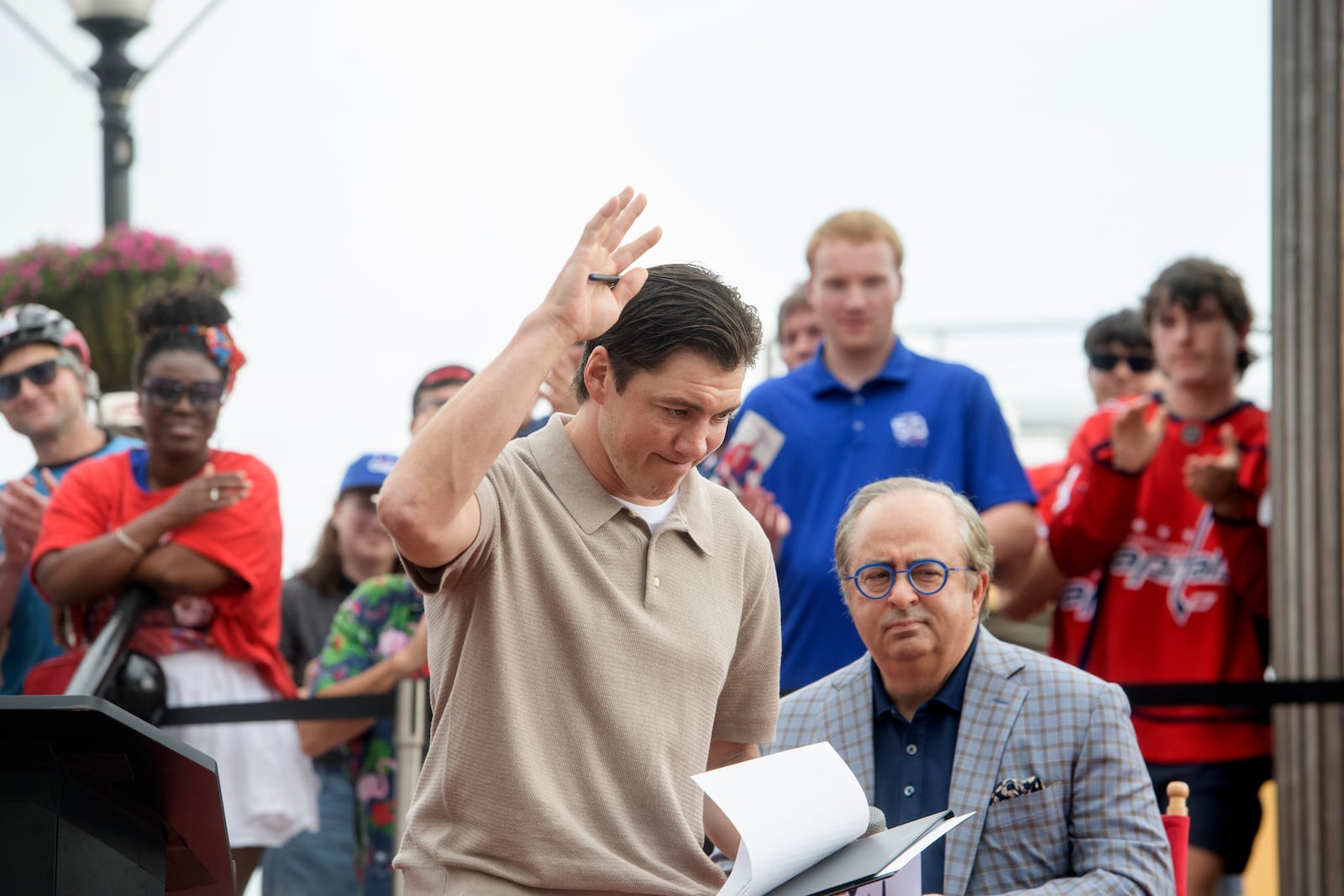 Washington Capitals forward T.J. Oshie acknowledges the crowd at Washington Harbour as he announces his retirement from the NHL, Monday, June 9, 2025, in Washington. (AP Photo/Rod Lamkey, Jr.)
