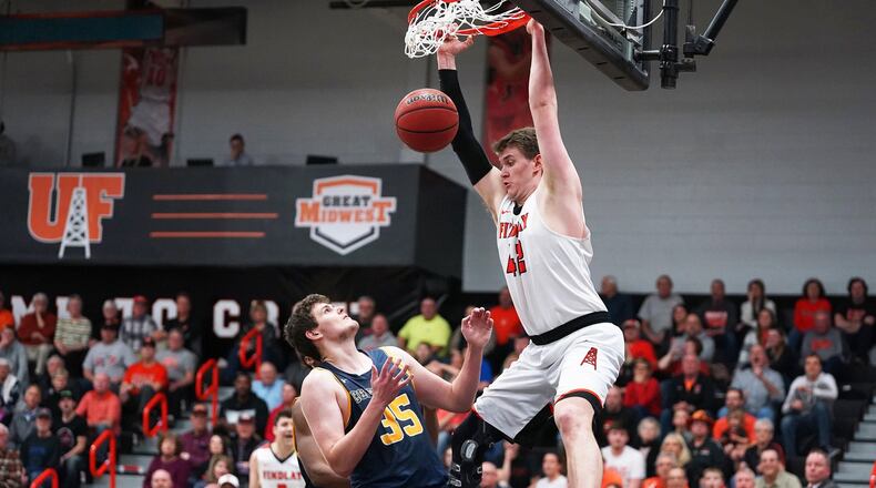 The University of Findlay’s Alex White gets a dunk March 8 during an 80-77 win over visiting Cedarville in a Great Midwest Athletic Conference tournament semifinal. PHOTO COURTESY OF FINDLAY ATHLETICS