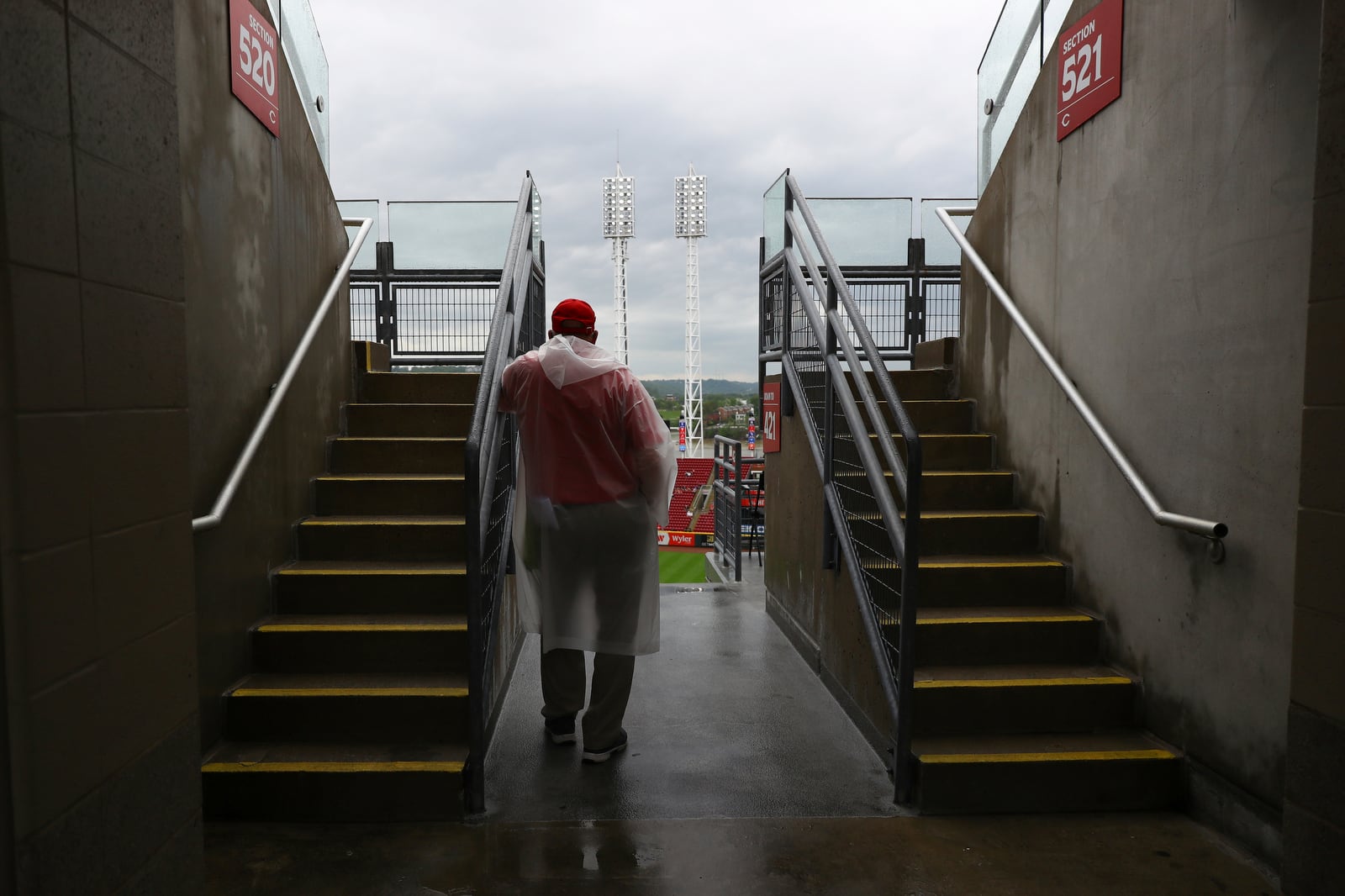 An usher looks on during a rain delay in a baseball game between the St. Louis Cardinals and Cincinnati Reds, Thursday, May 1, 2025, in Cincinnati. (AP Photo/Abdoul Sow)
