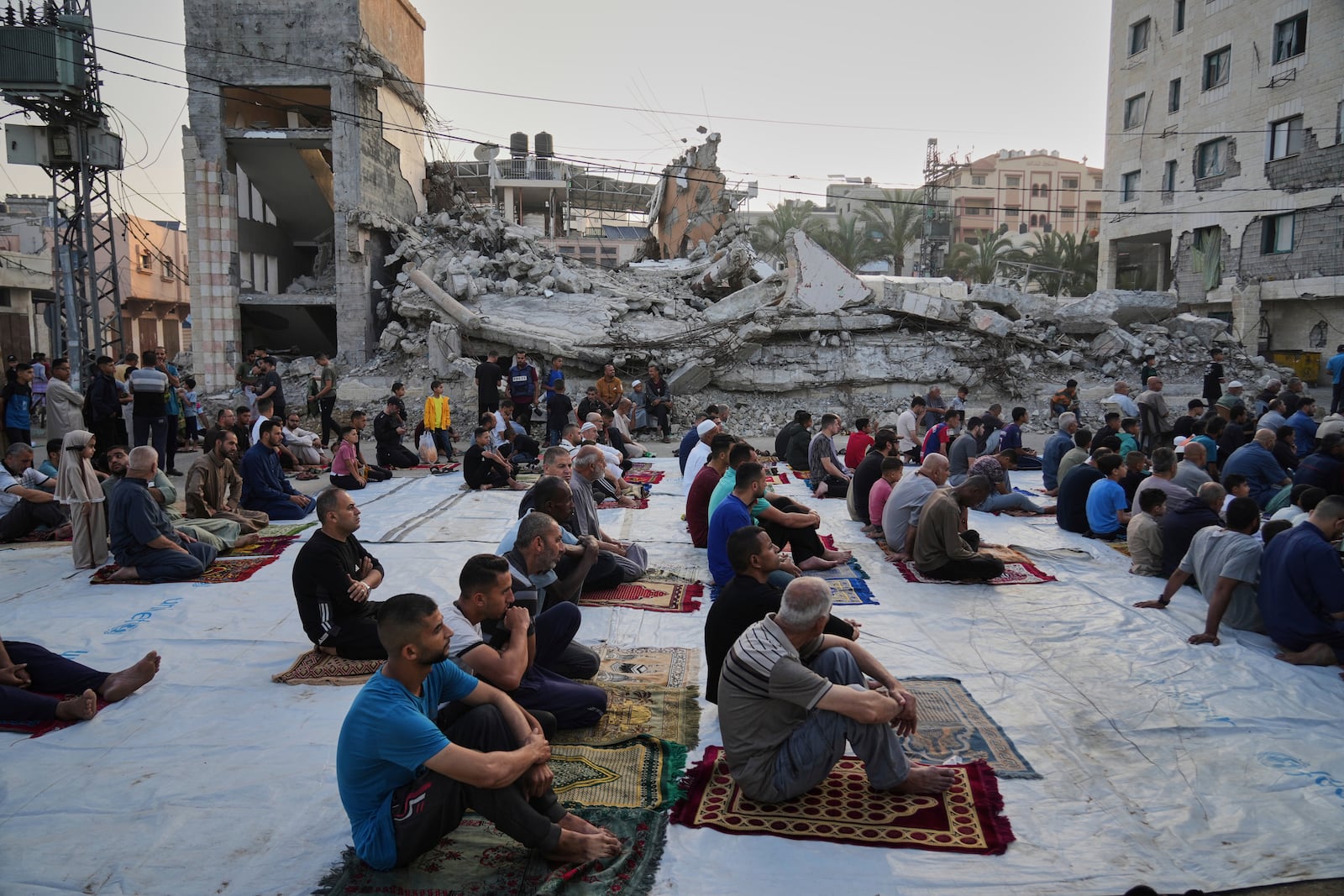 Palestinians gather for Eid al-Adha prayers beside the ruins of a mosque destroyed by Israeli bombardment, in Deir al-Balah, Gaza on Friday, June 6, 2025. (AP Photo/Abdel Kareem Hana)
