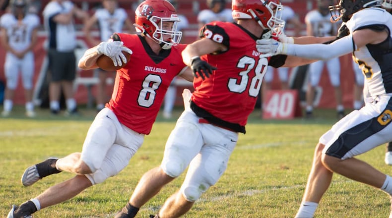 Milton-Union receiver Blake Brumbaugh follows a block by Michael Elam during the season-opening victory over Oakwood. CONTRIBUTED/Greg Seevers Photography