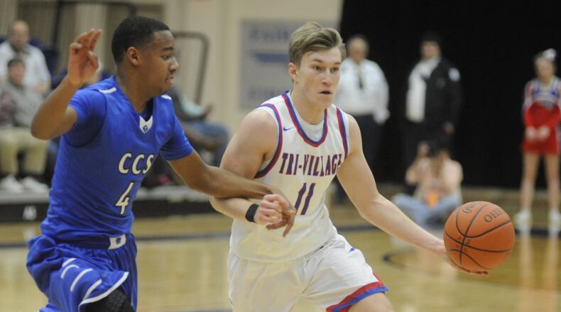 Cincinnati Christian’s Dylan Woods (left) defends Gavin Richards of New Madison Tri-Village on March 14, 2017, during a Division IV regional semifinal at Fairmont’s Trent Arena. CCS won 49-42. MARC PENDLETON/STAFF
