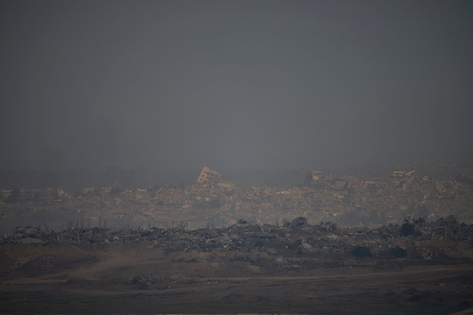 Destroyed buildings in the Gaza Strip are seen from a southern Israel location on Sunday, July 13, 2025. (AP Photo/Ohad Zwigenberg)
