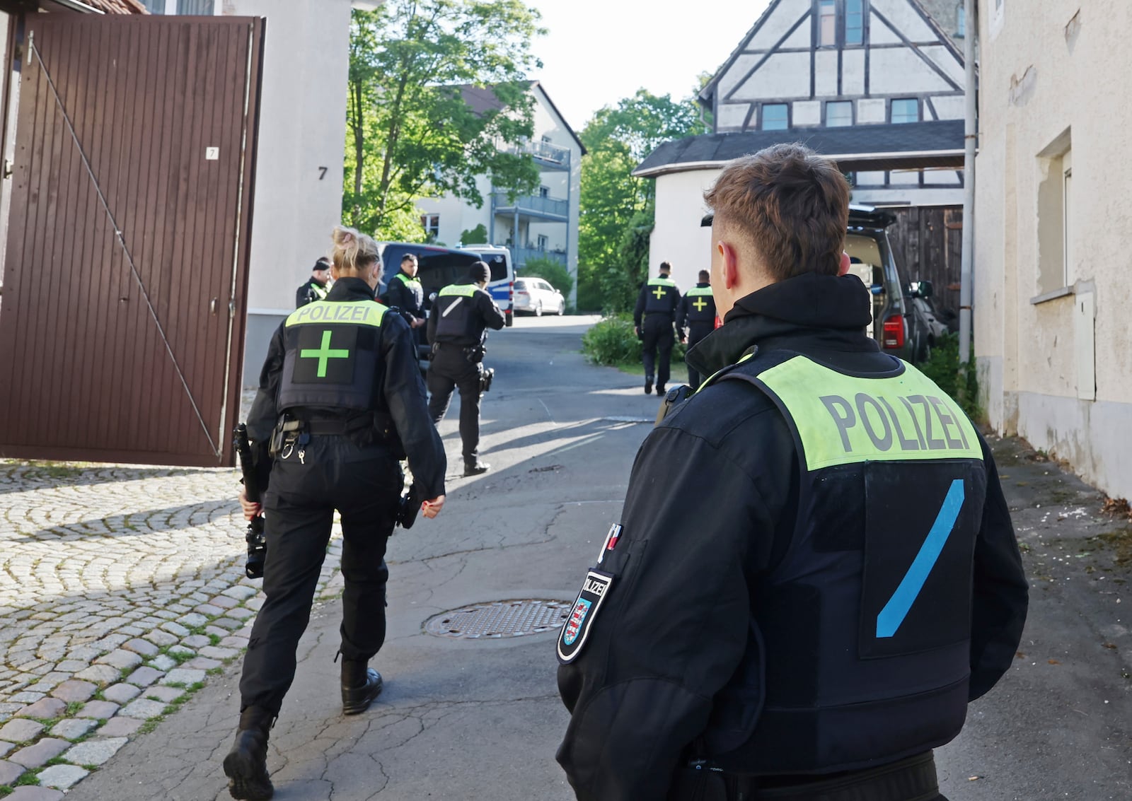 Police officers search buildings following the ban of the Reichsbürger group "Kingdom of Germany" in Gera, Germany, Tuesday, May 13, 2025. (Bodo Schackow/dpa via AP)