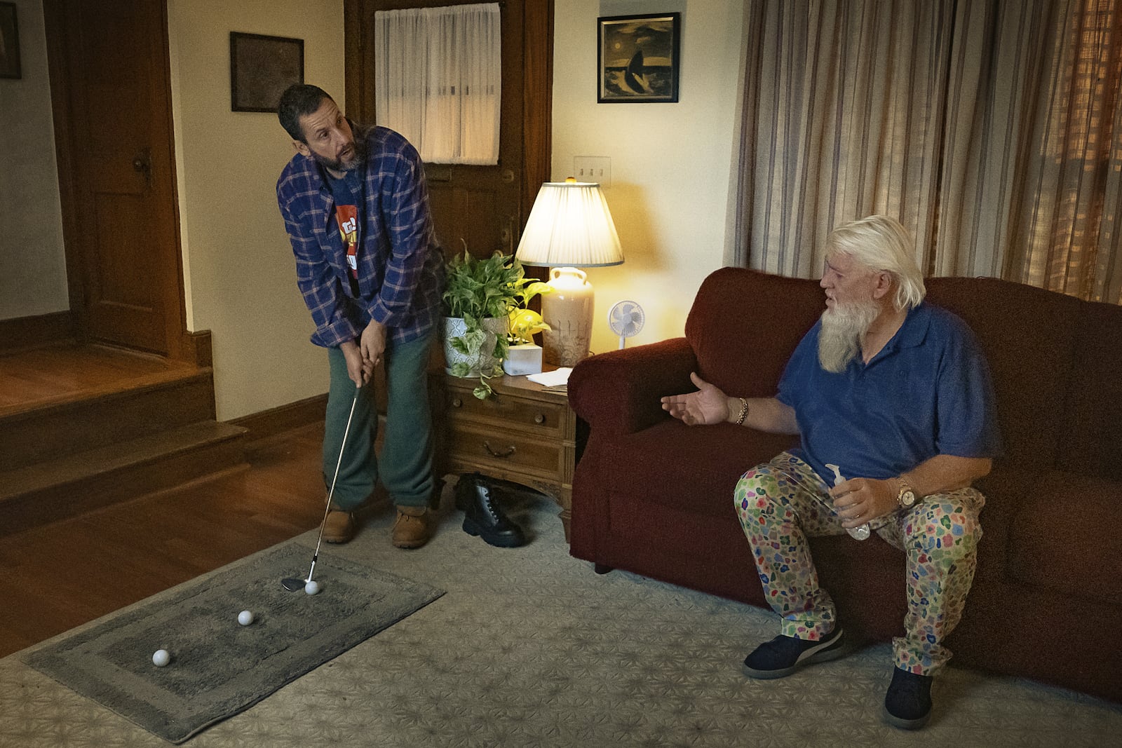 This image released by Netflix shows Adam Sandler, left, and John Daly in a scene from "Happy Gilmore 2." (Scott Yamano/Netflix via AP)