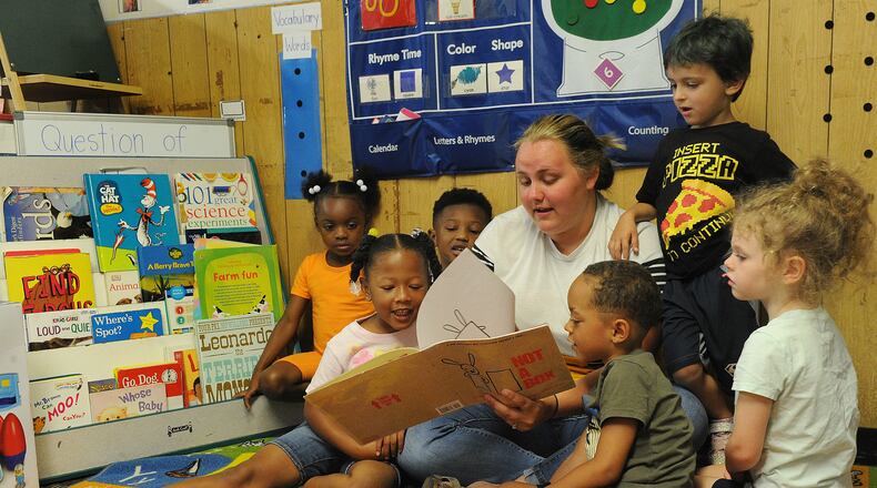 Breanna Sharp reads to her preschoolers Tuesday July 6, 2021 at the On Purpose Academy just north of downtown Dayton. Preschool Promise, which has served 4-year-olds in Dayton and Montgomery County for years, will now offer their services to 3-year-olds in the city of Dayton. MARSHALL GORBY\STAFF
