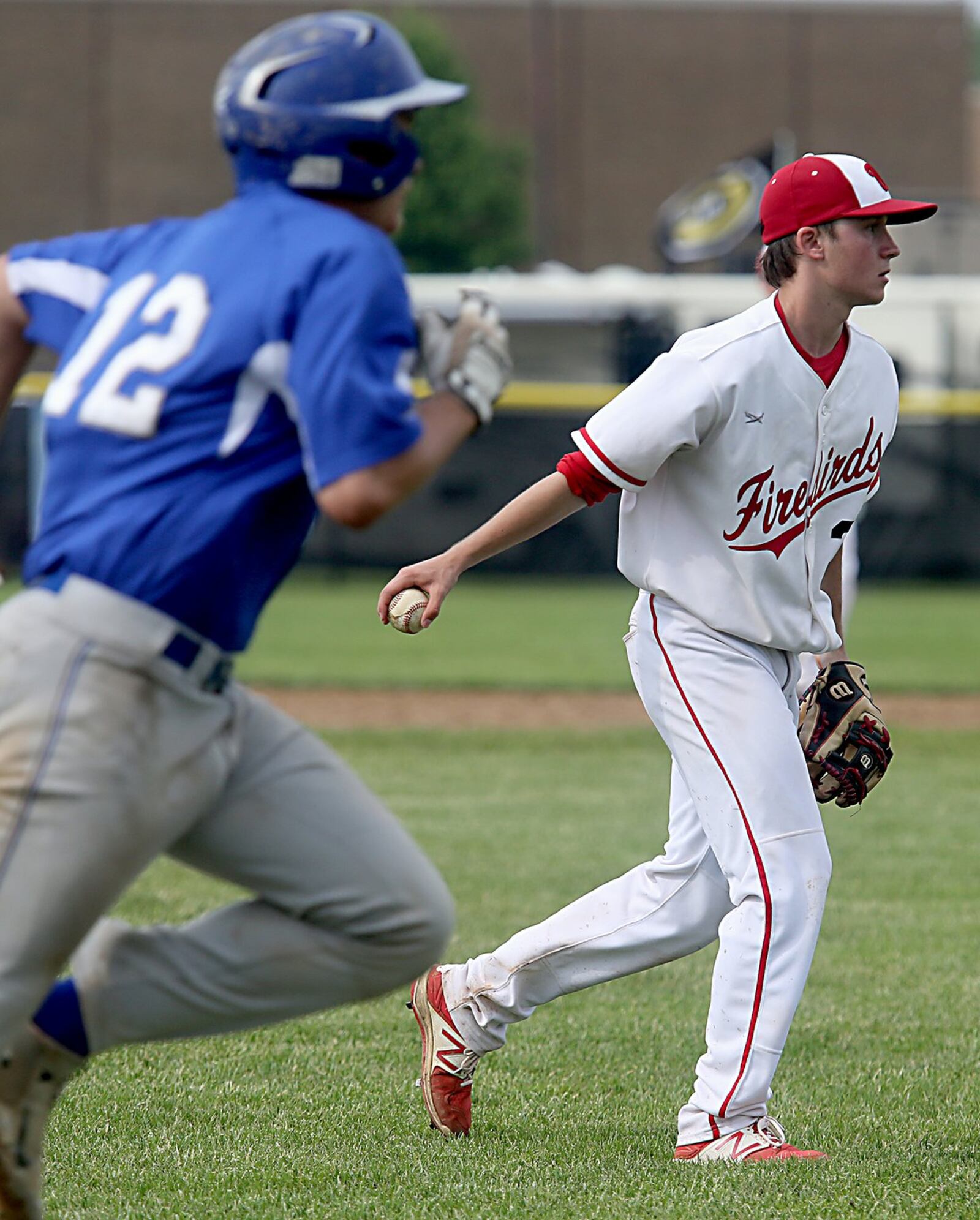 Lakota West pitcher Max Kiker tosses the ball to first base to get the out on Springboro’s Jacob Beachy during Saturday’s Division I district final at Centerville. CONTRIBUTED PHOTO BY E.L. HUBBARD