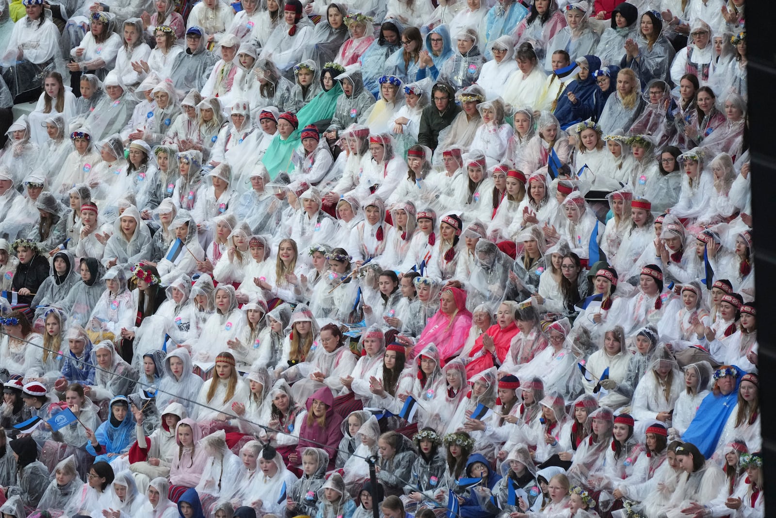 Choir singers take part in the Estonian Song Festival, part of the "Iseoma" Song and Dance Celebration, at the Song Festival Grounds in Tallinn, Estonia, Saturday, July 5, 2025. (AP Photo/Sergei Grits)