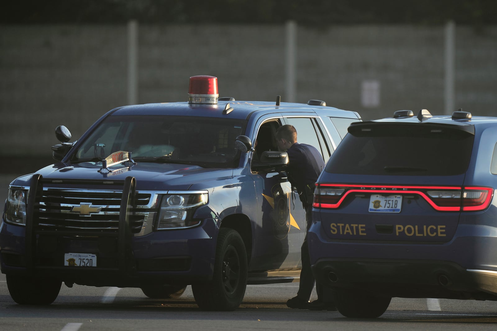 Law enforcement officers are seen stationed outside a Walmart where several people were stabbed in a violent attack Saturday, July 26, 2025, in Traverse City, Mich. (AP Photo/Ryan Sun)