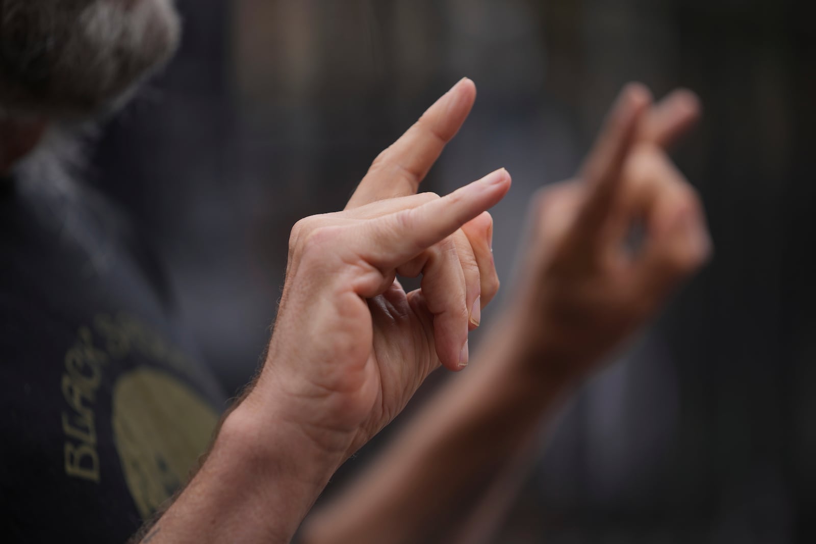 A music fan poses for a photograph to commemorate the death of Ozzy Osbourne at the Black Sabbath Bridge in Birmingham, Wednesday, July 23, 2025. (AP Photo/Kin Cheung)