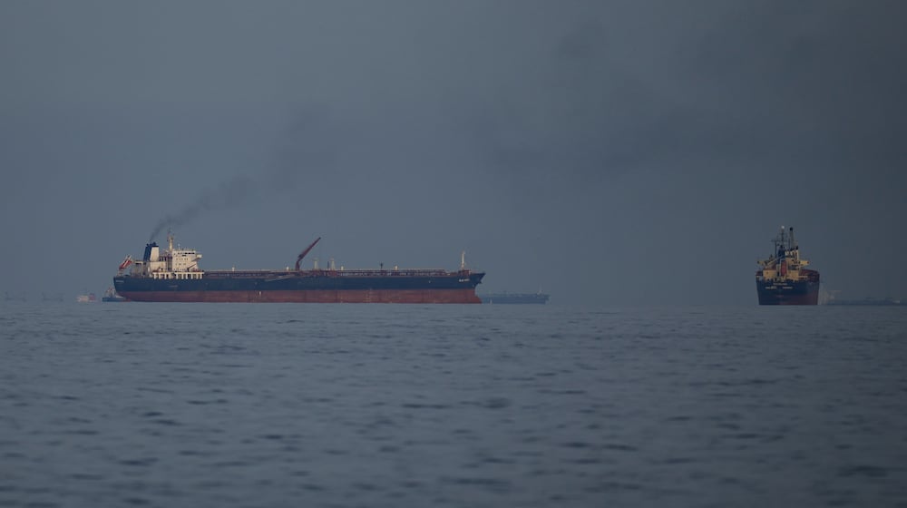 Oil tankers and cargo ships line up in the Strait of Hormuz as seen from Khor Fakkan, United Arab Emirates, Wednesday, March 11, 2026. (AP Photo/Altaf Qadri)