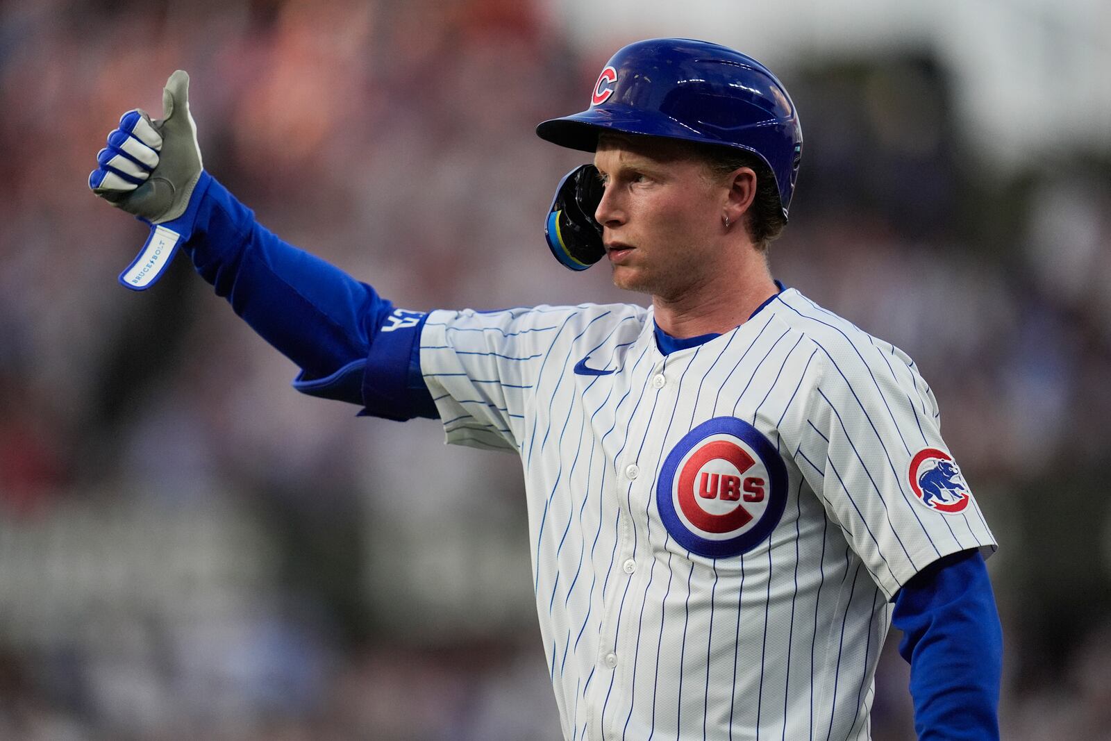 Chicago Cubs' Pete Crow-Armstrong (4) signals to the dugout after hitting a one-run single during the third inning of a baseball game against the Cleveland Guardians, Wednesday, July 2, 2025, in Chicago. (AP Photo/Erin Hooley)