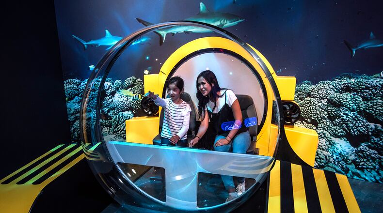 A partial replica of a Triton submersible provides a great photo opportunity for "Unseen Oceans" visitors who have cameras at the ready. ©AMNH/D. Finnin