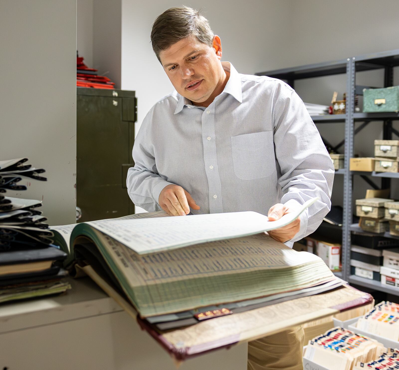 Kettering Municipal Court Clerk of Court Rob Scott looks over historical files in the Kettering Municipal Court on Thursday. BRYANT BILLING / STAFF