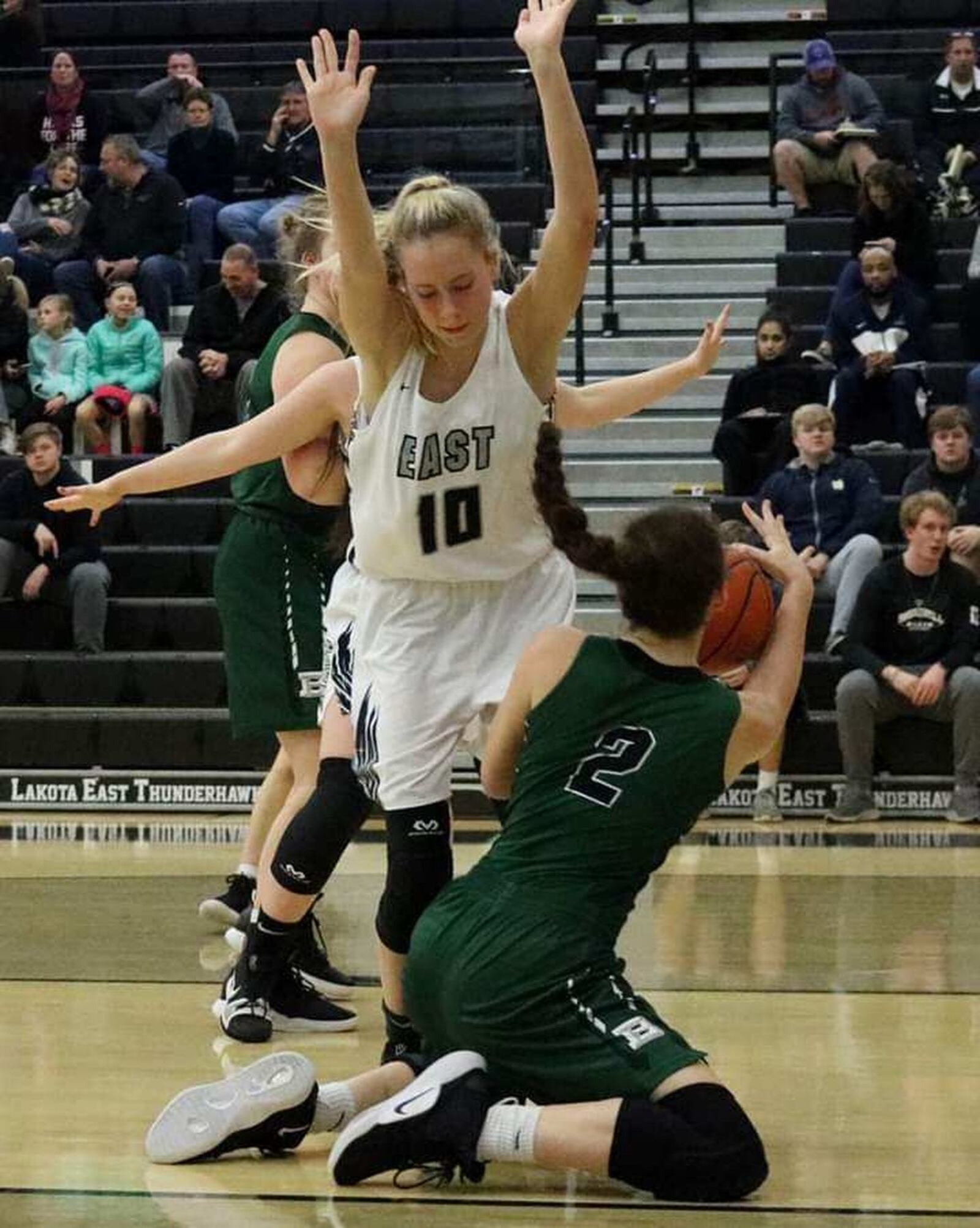 Badin’s Shelby Nusbaum (2) looks for some help under the basket as Lakota East’s Maddy Bley (10) defends Thursday night at East. The visiting Rams won 53-38. CONTRIBUTED PHOTO BY TERRI ADAMS