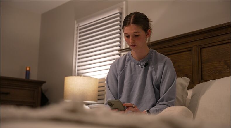 Middle school teacher Kate Stoye checks her sleep score on her phone, Wednesday, Jan. 7, 2026, in Hiram, Ga. (AP Photo/Emilie Megnien)