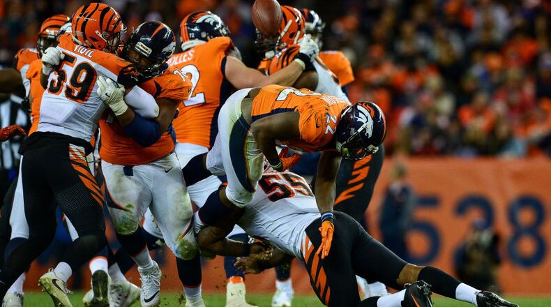 DENVER, CO - NOVEMBER 19: Running back C.J. Anderson #22 of the Denver Broncos fumbles the ball as he is hit by outside linebacker Vontaze Burfict #55 of the Cincinnati Bengals in the fourth quarter of a game at Sports Authority Field at Mile High on November 19, 2017 in Denver, Colorado. (Photo by Dustin Bradford/Getty Images)