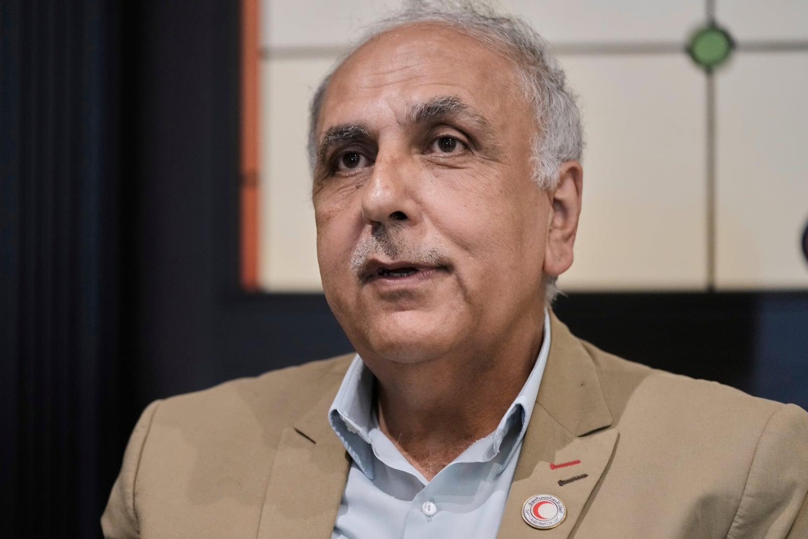 Dr. Mohammed Hazem Baqleh, president of the Syrian Arab Red Crescent, speaks during an interview with The Associated Press at the Habtoor Grand Hotel in the Sin el-Fil suburb of Beirut, Lebanon, Tuesday, July 22, 2025. (AP Photo/Bilal Hussein)