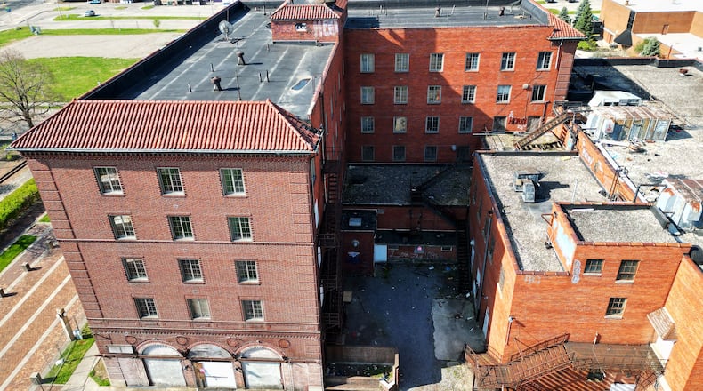A fence has been installed around Manchester Inn in Middletown as a precautionary measure after several roof tiles have fallen to the ground. NICK GRAHAM/STAFF
