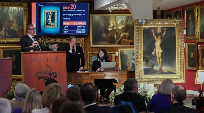 Auction officer Jean-Pierre Osenat gestures as the long-lost painting "Crucifixion of Jesus Christ" by Baroque master Peter Paul Rubens was sold at auction for 2,3 million euros or $2.66 million in Versailles, west of Paris, Nov. 30, 2025. (AP Photo/Michel Euler)