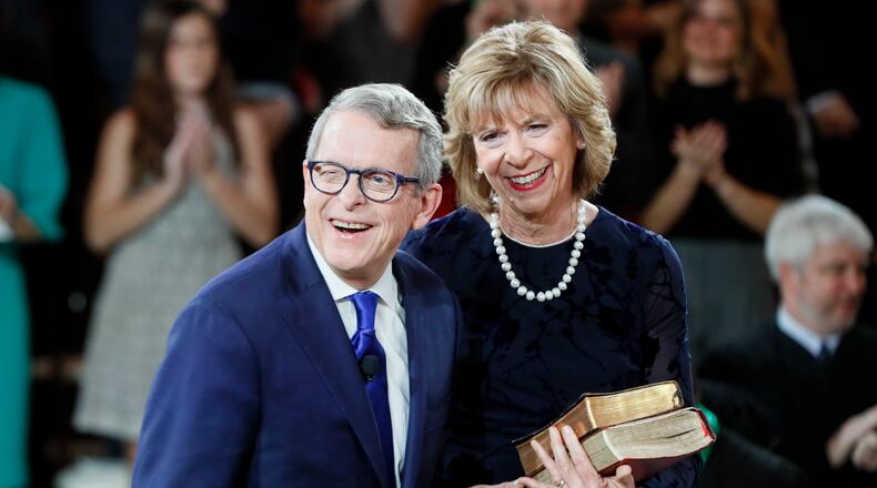 FILE - Ohio Gov. Mike DeWine, left, reacts after taking the oath of office alongside his wife, Fran, during an inauguration ceremony at the Ohio Statehouse Jan. 14, 2019, in Columbus. The DeWines announced they tested positive for COVID-19 and are experiencing mild symptoms. They are fully vaccinated and have received booster doses.