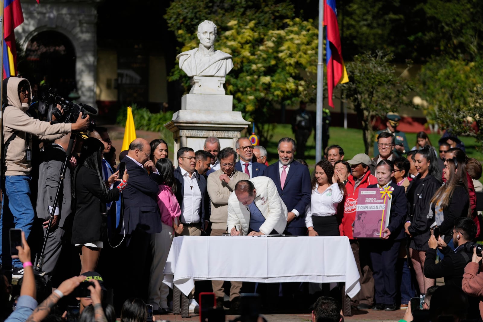 Colombia's Labor Minister Antonio Sanguino signs a labor reform bill into law in Bogota, Colombia, Wednesday, June 25, 2025. (AP Photo/Fernando Vergara)