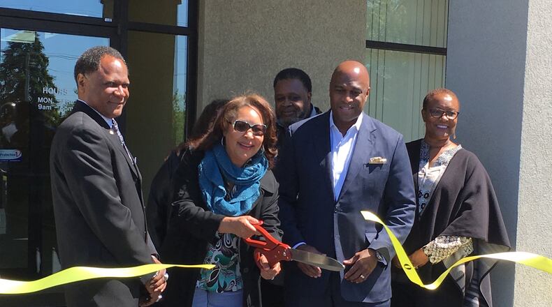 From left: Robert Haley, regional director of Choices, Dora Bronston, vice mayor of Middletown, Pastor David Green, Terrence Gray, corporate operations officer for Choices, and Cherie Toney, engagement director, attend the ribbon-cutting of the drug treatment center Monday in Middletown. RICK MCCRABB/STAFF