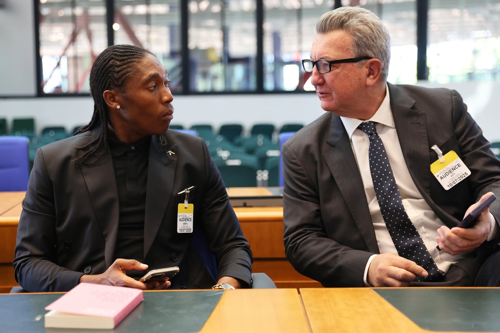 South Africa's Caster Semenya speaks to lawyer Gregory Nott, right, in the European Court of Human Rights before a decision over sex eligibility rules in sports, Thursday, July 10, 2025 in Strasbourg, eastern France. (AP Photo/Antonin Utz)