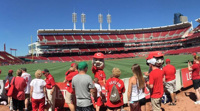Reds fans wait to take photos with players on Sunday, July 2, 2017, at Great American Ball Park before a game against the Cubs in Cincinnati.