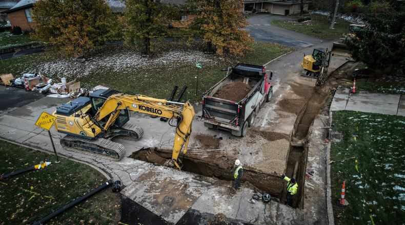 Workers replace old water pipes near the intersection of Folsom Drive and Knollview in Harrison Twp. Water distributors in southwest Ohio said rising maintenance and operating costs are factors in customer water rate increases.  JIM NOELKER/STAFF