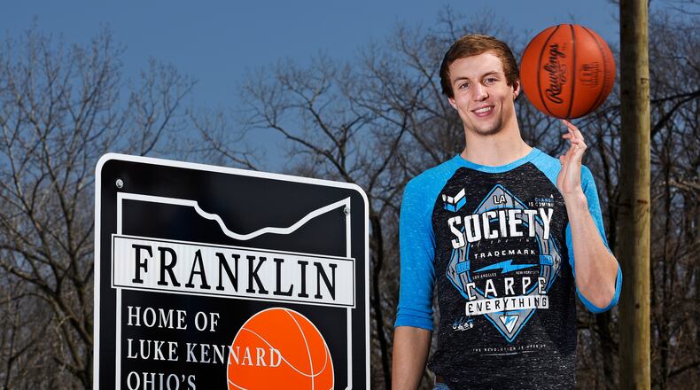 In this 2015 file photo, then-Franklin High School senior Luke Kennard stands next to one of the signs that were installed in Franklin honoring his Ohio Mr. Basketball honor. Around the time of the NBA draft, two of the five signs have been stolen forcing the city to take down the others. NICK GRAHAM/ STAFF