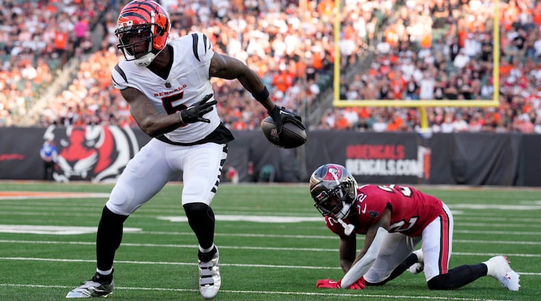 Cincinnati Bengals wide receiver Tee Higgins (5) gets past Tampa Bay Buccaneers defensive back Josh Hayes (32) as Higgins scores a touchdown in the first half of an NFL preseason football game Saturday, Aug. 10, 2024, in Cincinnati. (AP Photo/Jeff Dean)