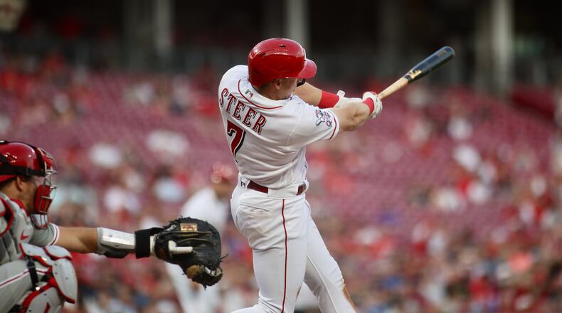 Spencer Steer, of the Reds, singles to drive in a run in the third inning against the Phillies on Thursday, April 13, 2023, at Great American Ball Park in Cincinnati. David Jablonski/Staff