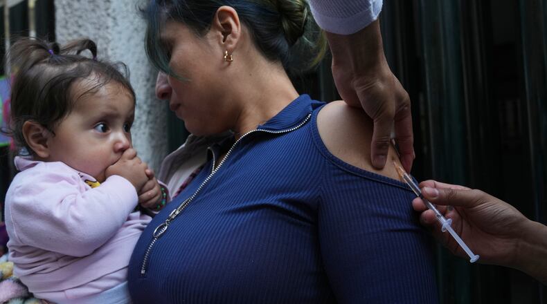 A health worker administers a dose of the measles vaccine outside a public hospital in Mexico City, Wednesday, Feb. 4, 2026. (AP Photo/Marco Ugarte)