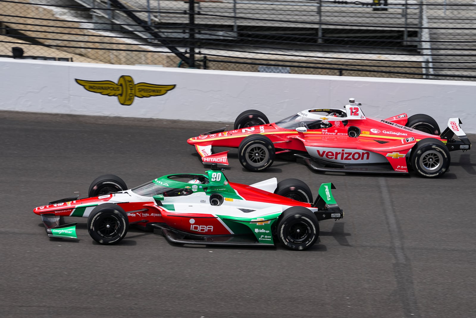 Callum Ilott, of the United Kingdom, (90) and Will Power, of Australia, drive into the first turn during practice for the Indianapolis 500 auto race at the Indianapolis Motor Speedway in Indianapolis, Monday, May 19, 2025. (AP Photo/Michael Conroy)