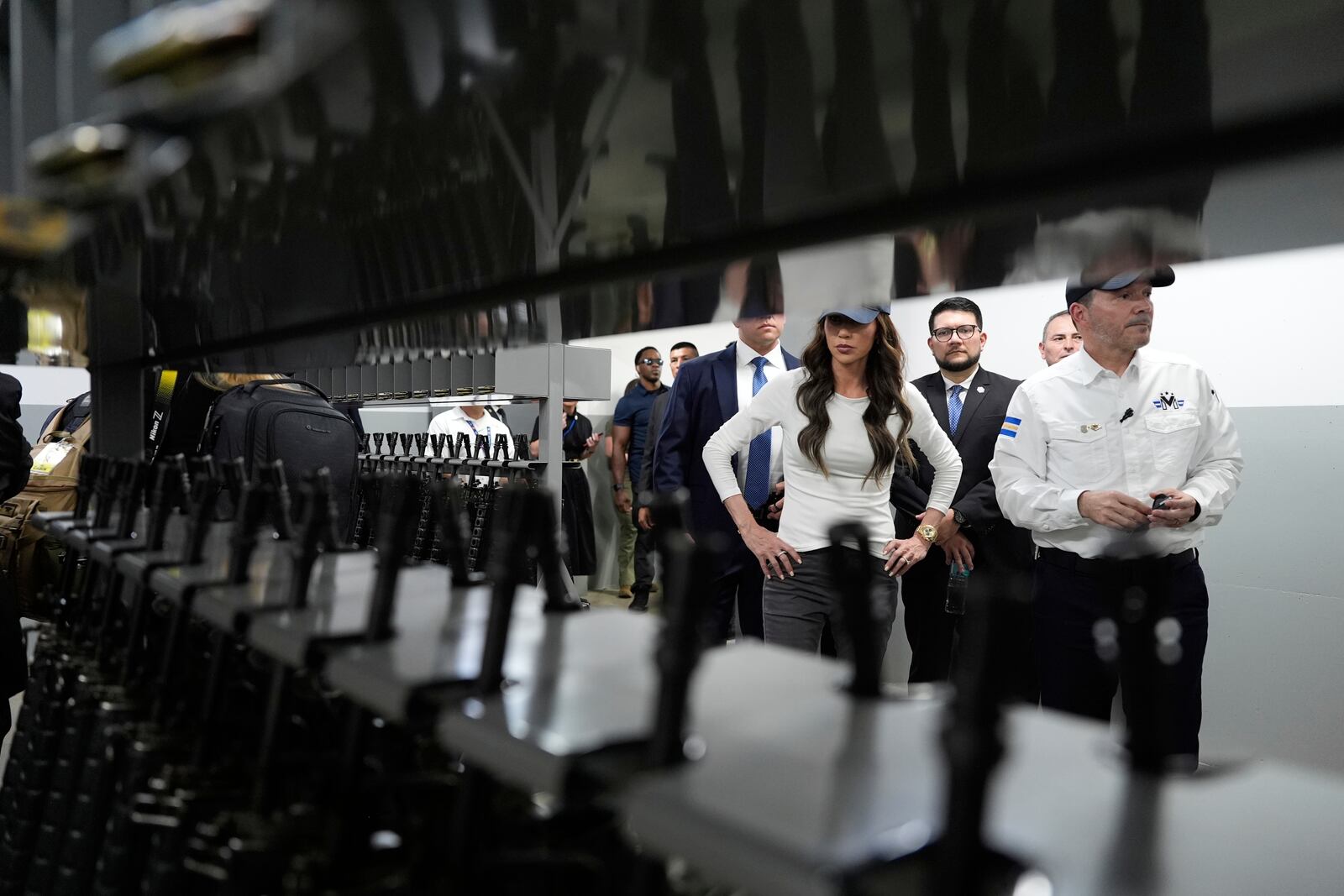 Homeland Security Secretary Kristi Noem looks at weapons during a tour of the Terrorist Confinement Center in Tecoluca, El Salvador, Wednesday, March 26, 2025. (AP Photo/Alex Brandon)