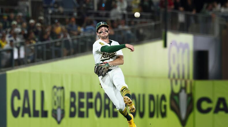 FILE - Athletics shortstop Jacob Wilson throws to first base during the seventh inning of a baseball game against the Kansas City Royals in West Sacramento, Calif., Sept. 27, 2025. (AP Photo/Sara Nevis, File)