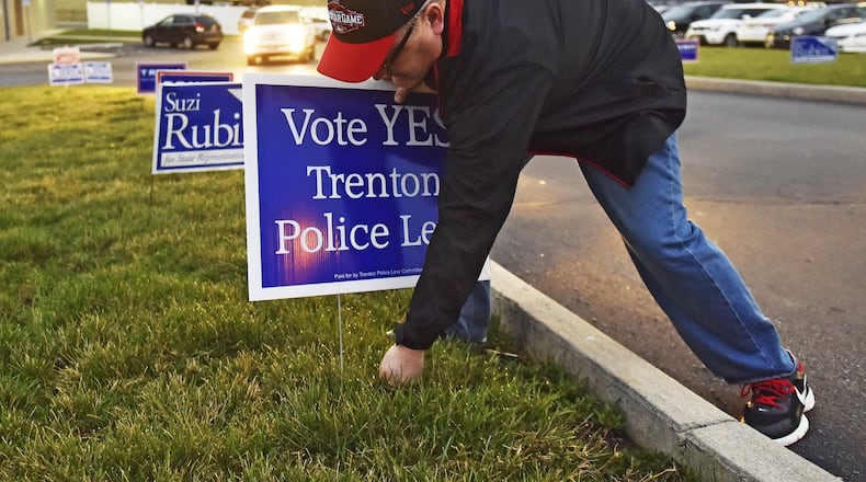 Voters overwhelmingly approved a 5.25 mill permanent police levy in March which has had a big impact on the city’s 2017 budget. Pictured here is Trenton City Manager John Jones putting up signs supporting the Trenton police levy on March 15 at Edgewood Middle School in St. Clair Township. NICK GRAHAM/STAFF