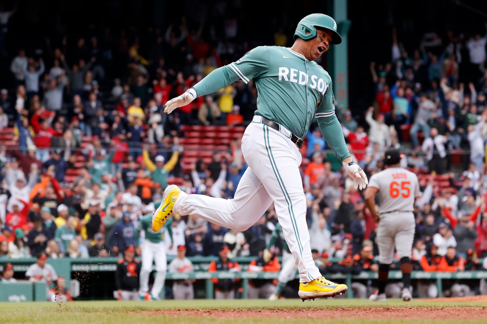 Boston Red Sox designated hitter Rafael Devers (11) reacts after hitting the game-winning RBI single during the tenth inning of the first baseball game of a doubleheader against the Baltimore Orioles, Saturday, May 24, 2025, at Fenway Park in Boston. (AP Photo/Mary Schwalm)