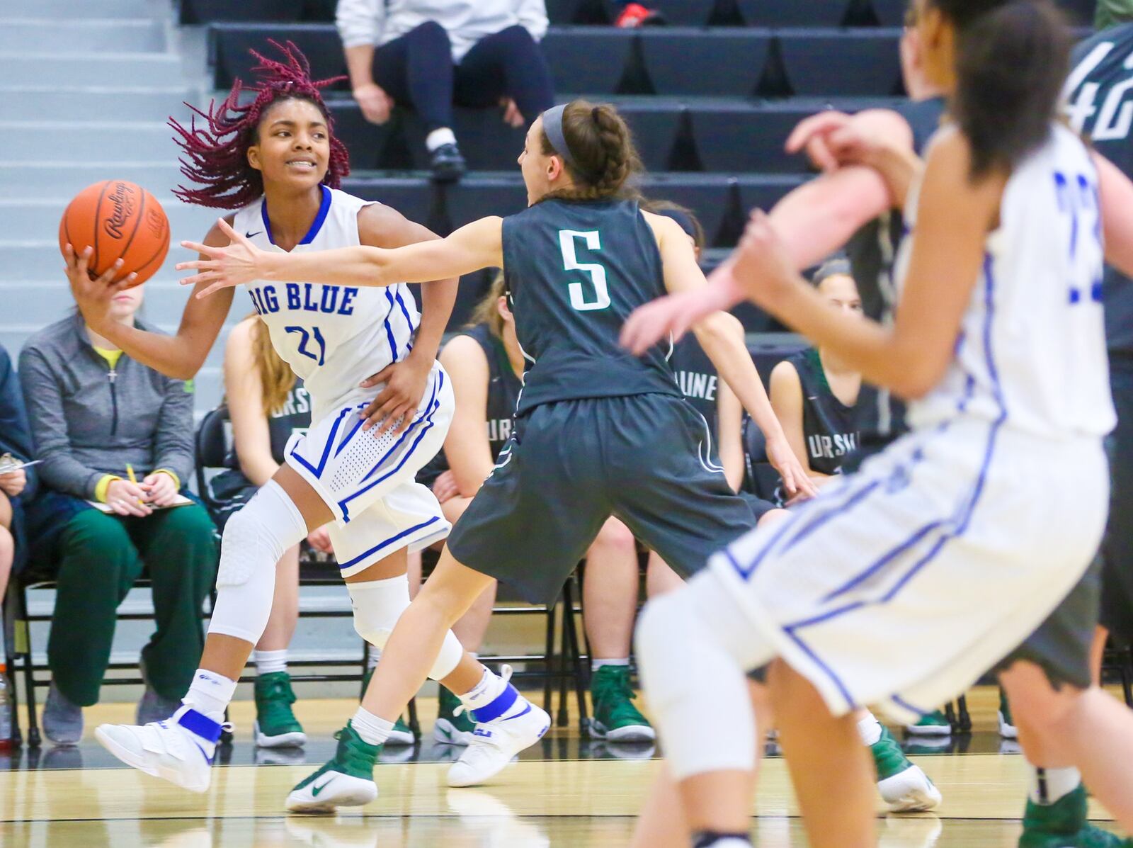 Hamilton guard Cici Riggins (21) looks to pass to a teammate during a Division I sectional game against Ursuline on Feb. 21 at Lakota East. GREG LYNCH/STAFF