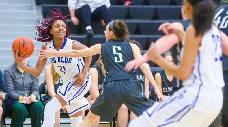 Hamilton guard Cici Riggins (21) looks to pass to a teammate during a Division I sectional game against Ursuline on Feb. 21 at Lakota East. GREG LYNCH/STAFF