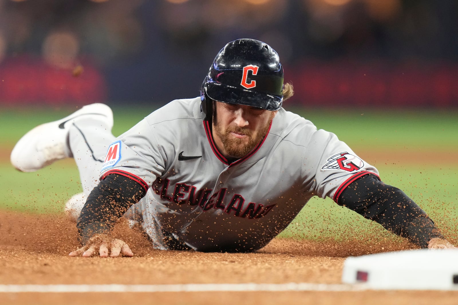 Cleveland Guardians' Daniel Schneemann slides into third base during the sixth inning of a baseball game against the Toronto Blue Jays in Toronto on Friday, May 2, 2025. (Chris Young/The Canadian Press via AP)