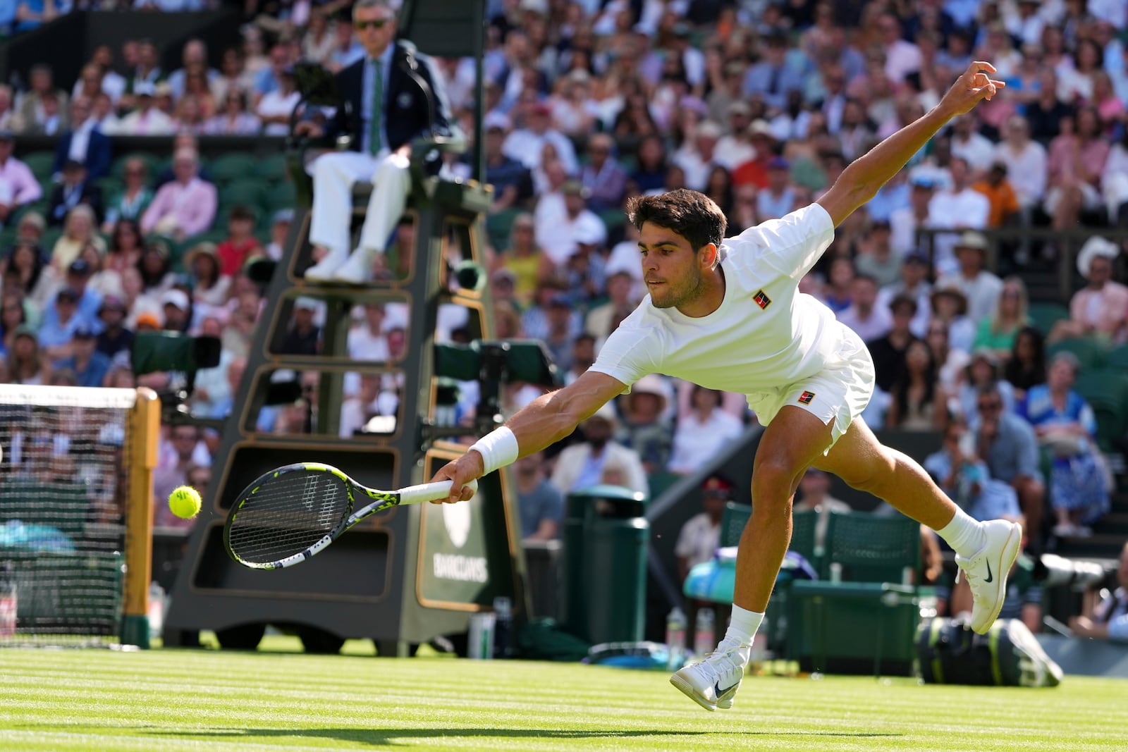Carlos Alcaraz of Spain returns the ball to Oliver Tarvet of Britain in his second round men's singles match at the Wimbledon Tennis Championships in London, Wednesday, July 2, 2025.(AP Photo/Kirsty Wigglesworth)