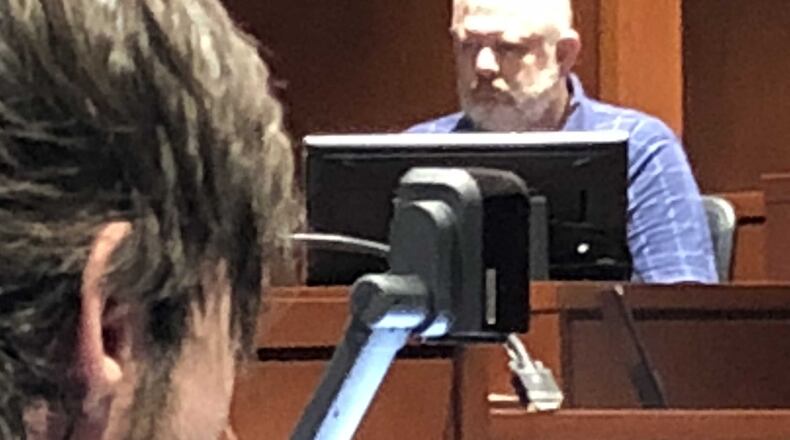 Christopher Kirby listens as Kevin Power, a relative, testified about the extended family living in the South Lebanon home where Kirby is alleged to have murdered his adoptive sister, Deborah Power. STAFF/LAWRENCE BUDD